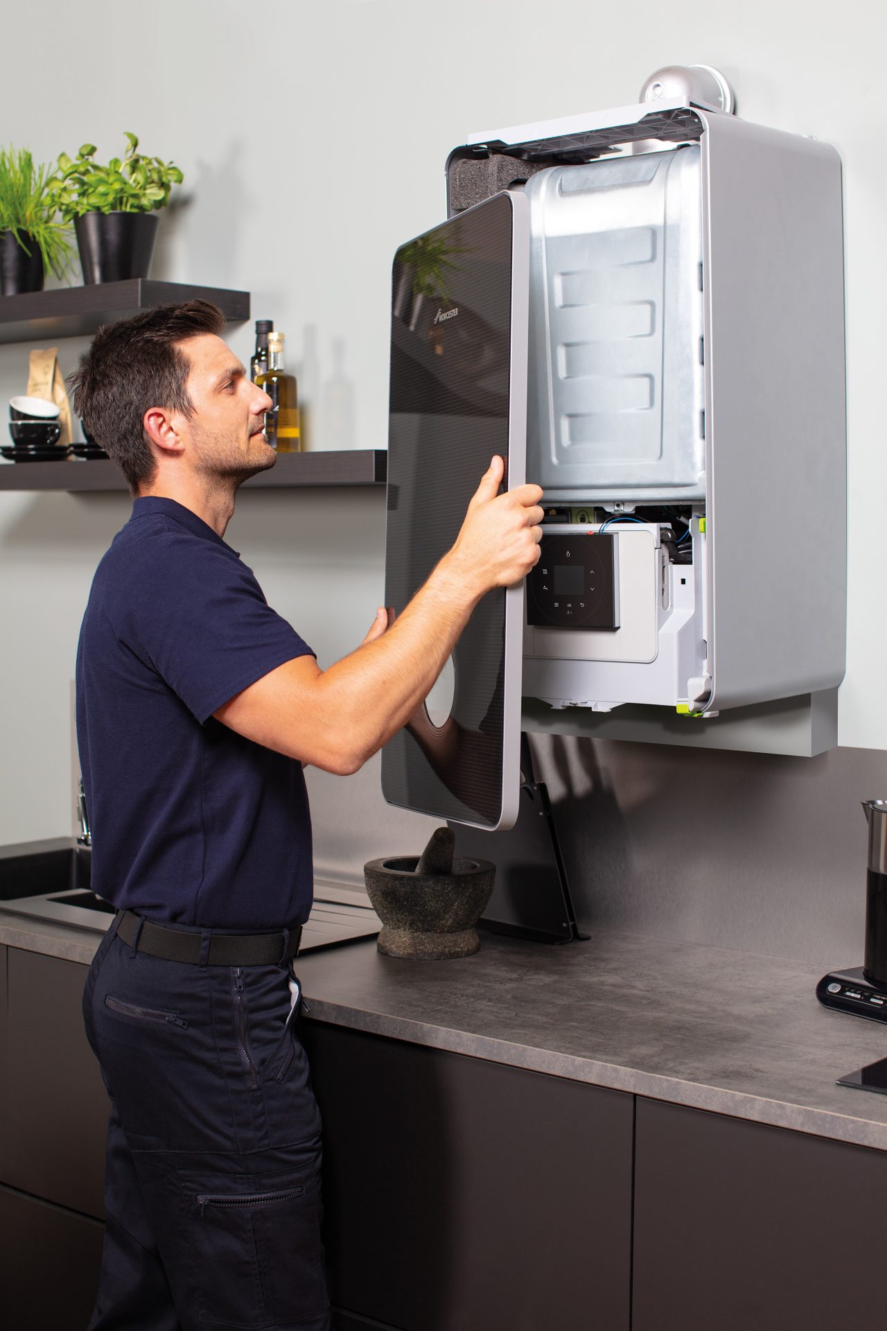Plumber fitting a new boiler